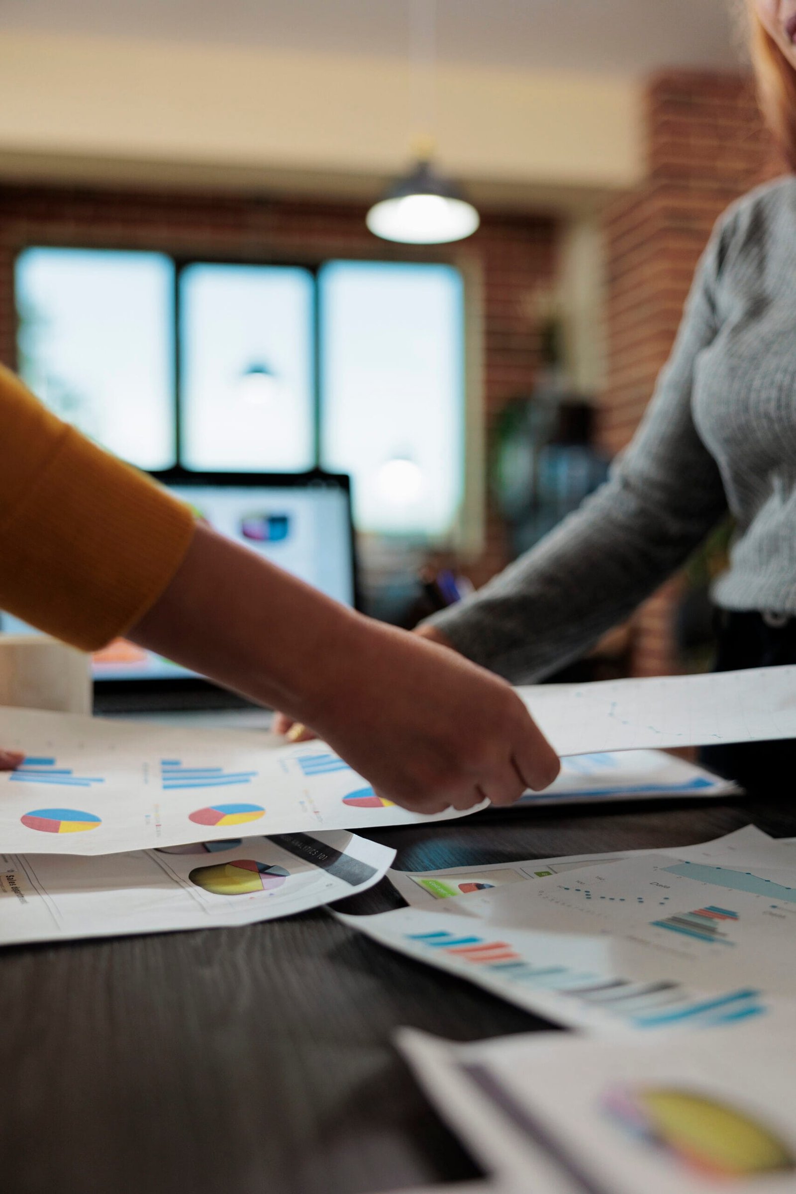 Close up of women entrepreneur holding papers with company statistics